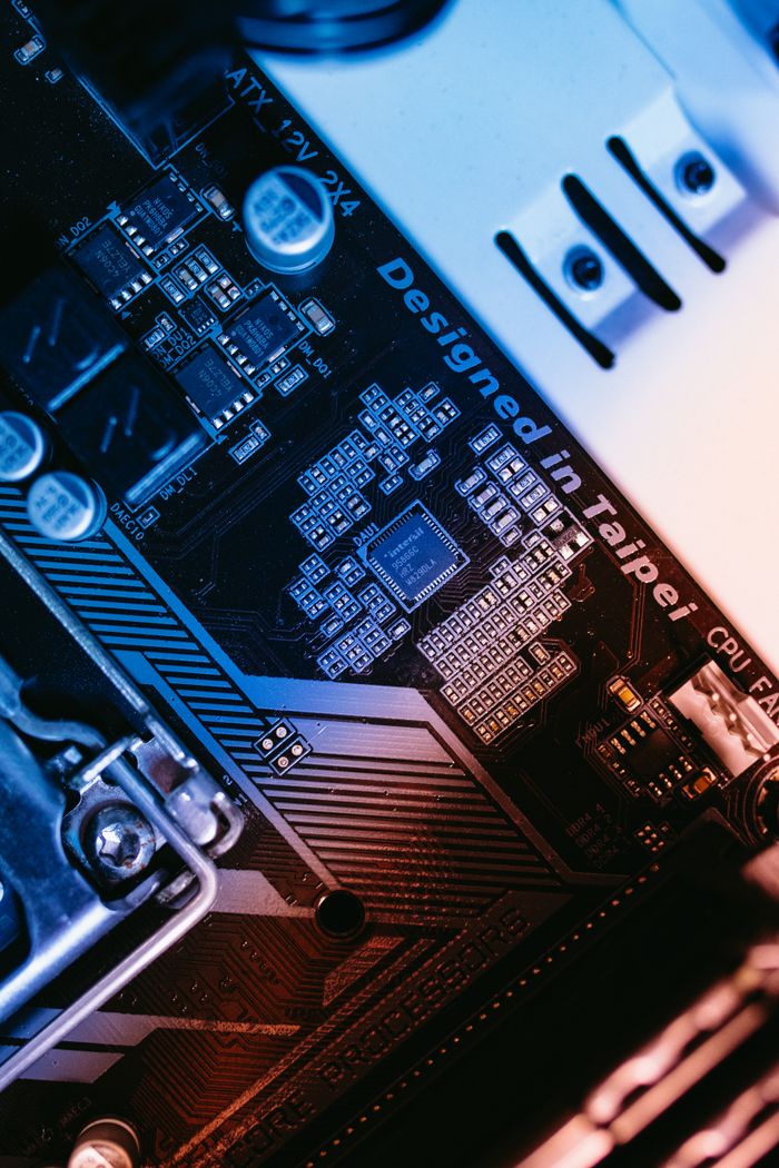 Services-03 Macro shot of a computer motherboard focused on chips and circuits, designed in Taipei.